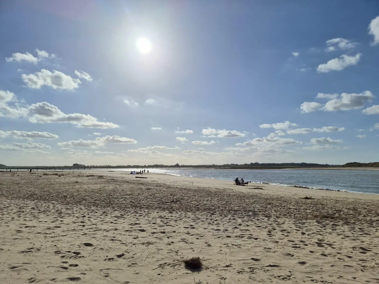 Brede zandvlakte en geul bij Het Zwin onder een zonnige lucht